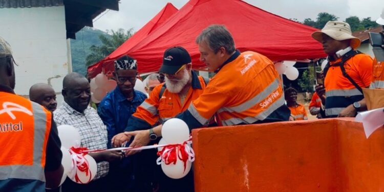 ArcelorMittal Liberia executives and community leaders cut ribbon to dedicate new solar-powered water kiosks in Yekepa, Nimba County.