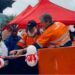 ArcelorMittal Liberia executives and community leaders cut ribbon to dedicate new solar-powered water kiosks in Yekepa, Nimba County.