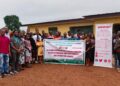Group photo of participants at ActionAid Liberia’s County-Level National People’s Summit on Climate Justice in Bong County, holding a banner promoting agroecology, people-driven climate finance, and sustainable solutions for Liberia.