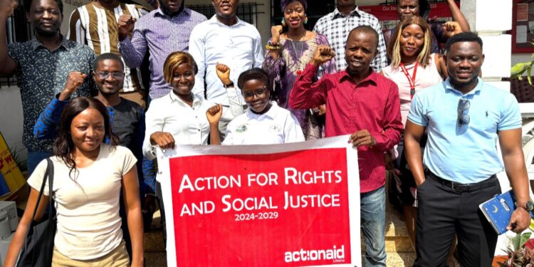 Group photo of ActionAid Liberia staff and youth-led organizations holding a banner for the Youth AHEAD Project launch focused on rights and social justice.