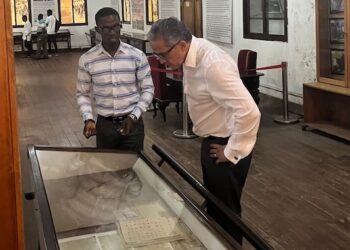 Prof. Dr. Khaled El-Enany tours the National Museum of Liberia with a guide, viewing historical documents during his UNESCO campaign visit.