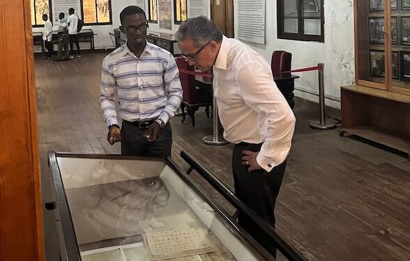 Prof. Dr. Khaled El-Enany tours the National Museum of Liberia with a guide, viewing historical documents during his UNESCO campaign visit.