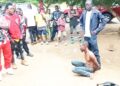 Crowd gathers around arrested Guinean national accused of plotting witchcraft assassination attempt against Nimba Senator Samuel G. Kogar in Liberia