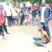 Crowd gathers around arrested Guinean national accused of plotting witchcraft assassination attempt against Nimba Senator Samuel G. Kogar in Liberia
