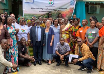 Participants at Liberia’s AICA launch under banner reading ‘Alliance for Indigenous Peoples and Local Communities for Conservation in Africa.’