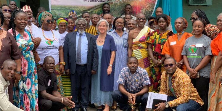 Participants at Liberia’s AICA launch under banner reading ‘Alliance for Indigenous Peoples and Local Communities for Conservation in Africa.’