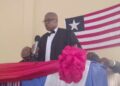 Resident Judge Boimah Kontoe speaking at a judicial program in Gbarnga, Bong County, with the Liberian flag in the background.