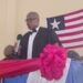 Resident Judge Boimah Kontoe speaking at a judicial program in Gbarnga, Bong County, with the Liberian flag in the background.