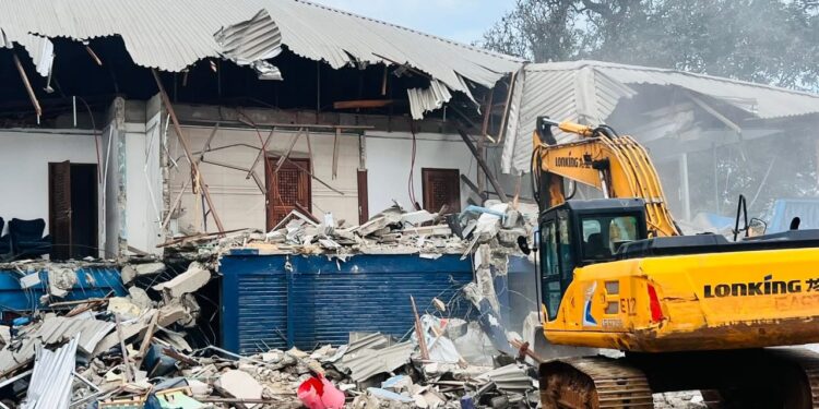 Excavator demolishes CDC headquarters building in Monrovia during court-ordered eviction operation.
