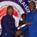 Christopher C. Walker shakes hands with Information Minister Jerelinmek Piah