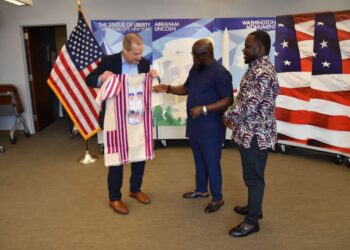 Outgoing U.S. Ambassador Mark Toner receiving a traditional Liberian gown from OK FM Manager Clarence Jackson and Editor Trokon Wrepue during a farewell ceremony at the U.S. Embassy in Monrovia.