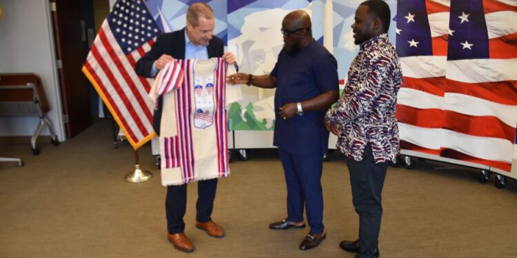 Outgoing U.S. Ambassador Mark Toner receiving a traditional Liberian gown from OK FM Manager Clarence Jackson and Editor Trokon Wrepue during a farewell ceremony at the U.S. Embassy in Monrovia.