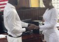 Former Liberia striker Dweh Allison exchanges rings with his longtime partner Linda M. Settro during their wedding ceremony at the Monrovia City Court