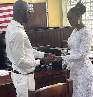 Former Liberia striker Dweh Allison exchanges rings with his longtime partner Linda M. Settro during their wedding ceremony at the Monrovia City Court