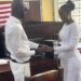 Former Liberia striker Dweh Allison exchanges rings with his longtime partner Linda M. Settro during their wedding ceremony at the Monrovia City Court