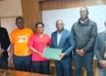 Officials from the Ministry of Health, NAHWUL, and Ecobank Liberia pose after signing a landmark MOU to improve financial access for Liberian health workers.