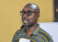 Eddie D. Jarwolo, Executive Director of Naymote, addresses participants during a presentation on equitable county development funding in Liberia.