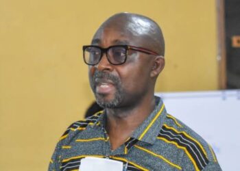 Eddie D. Jarwolo, Executive Director of Naymote, addresses participants during a presentation on equitable county development funding in Liberia.