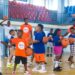 Young participants at Flames Basketball youth camp in Monrovia practicing dribbling drills on the court with coaches