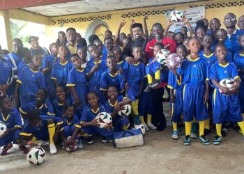 Children in jerseys at the launch of Believers Eastern Church Football Academy in Monrovia, blending sports and education.