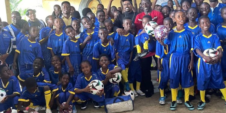 Children in jerseys at the launch of Believers Eastern Church Football Academy in Monrovia, blending sports and education.