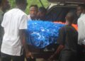 Pallbearers carry the flower-covered casket of Liberia U-20 footballer Gabrielle Sabina Lines during her funeral in Cotton Tree, Margibi County.
