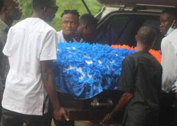 Pallbearers carry the flower-covered casket of Liberia U-20 footballer Gabrielle Sabina Lines during her funeral in Cotton Tree, Margibi County.