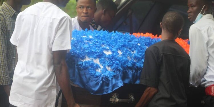 Pallbearers carry the flower-covered casket of Liberia U-20 footballer Gabrielle Sabina Lines during her funeral in Cotton Tree, Margibi County.