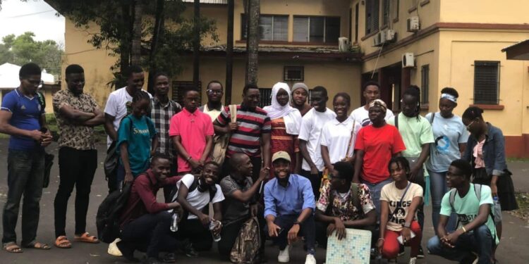 Group of young Liberian writers and literature students gathered outside the University of Liberia campus