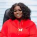 Gertrude Nyaley seated in red outfit, representing women’s leadership in Liberia’s forestry sector