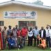 Officials and community members pose in front of the Liberia Land Authority County Office in Gbarnga following the successful resolution of a decades-old land dispute with LACRA.