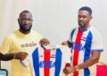 Mamadee Sheriff (left) receives the Nimba County football jersey from Alphanso Glaydor after being reappointed as head coach ahead of the 2025–26 County Sports Meet.