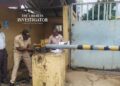 Court officers padlocking NEC premises during enforcement of a Commercial Court ruling in Monrovia.