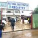 Employees and visitors enter National Identification Registry compound in Congo Town as biometric ID rollout remains stalled.