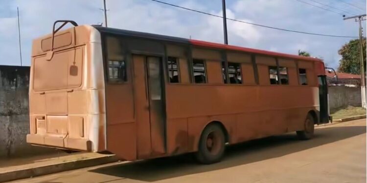 Two National Transit Authority buses in Liberia—one rusted and parked, the other surrounded by stranded commuters in Maryland County amid rising fare concerns.