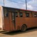 Two National Transit Authority buses in Liberia—one rusted and parked, the other surrounded by stranded commuters in Maryland County amid rising fare concerns.