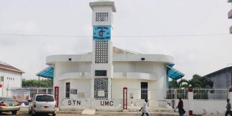 Congregants and community members gather for a tense United Methodist Church meeting amid ongoing conflict over the closure of S.T. Nagbe UMC in Monrovia, Liberia.