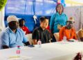 Sen. Saah Joseph sits with a Chinese guest at the launch of his new People Action Party in Monrovia, raising foreign influence questions.