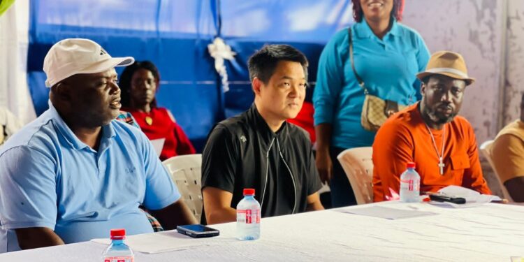Sen. Saah Joseph sits with a Chinese guest at the launch of his new People Action Party in Monrovia, raising foreign influence questions.