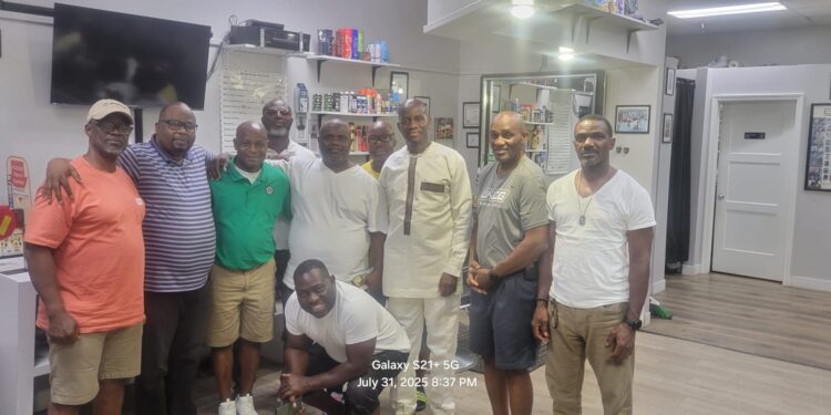 Sen. Saah Joseph with members of the Liberian community at Hands-On and Barber Business Center in Brooklyn Park, Minnesota.