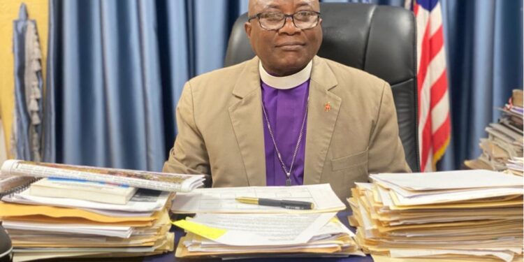 Bishop Samuel J. Quire Jr., Resident Bishop of the United Methodist Church in Liberia, seated at his desk addressing allegations linking the church to same-sex marriage