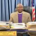Bishop Samuel J. Quire Jr., Resident Bishop of the United Methodist Church in Liberia, seated at his desk addressing allegations linking the church to same-sex marriage