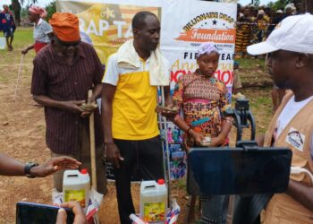 Billionaire Drap Tap Foundation outreach team handing supplies to community members in Grand Bassa County