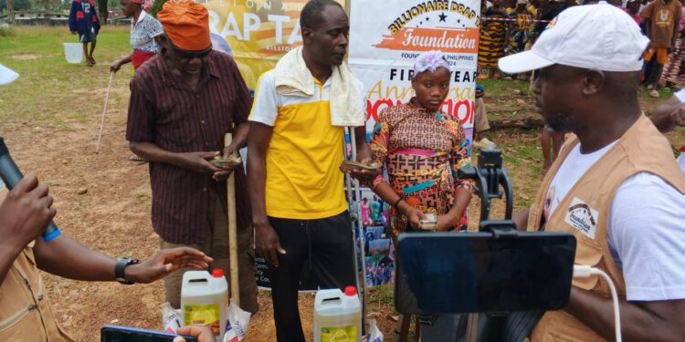 Billionaire Drap Tap Foundation outreach team handing supplies to community members in Grand Bassa County