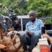 Arrested Radio BKS staff member seated near a motorcycle after being detained for allegedly carrying a locally made firearm in Nimba County on election day.