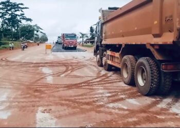 Construction trucks paving road in Tappita, Lower Nimba, Liberia