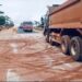 Construction trucks paving road in Tappita, Lower Nimba, Liberia