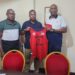 Cestos Mogars Basketball Club and Bukonjadeh Group of Companies executives hold up the team’s jersey after signing a one-year sponsorship deal in Monrovia