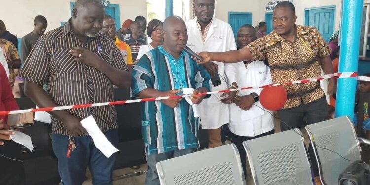 Local officials and healthcare workers cut ribbon during dedication of new outpatient department at Pleebo Health Center, Maryland County, Liberia.