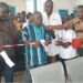 Local officials and healthcare workers cut ribbon during dedication of new outpatient department at Pleebo Health Center, Maryland County, Liberia.